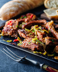 Roasted sliced barbecue pork ribs, seasoned with a spicy basting sauce and served with vegetables.