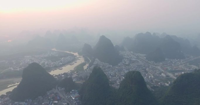 Top view of amaizing famous Yangshuo valley in Guilin, Guangxi, China. Aerial View of beautiful sunrise over Yulong or Dragon River in Yangshuo, China. Overpopulation concept, beauty in nature