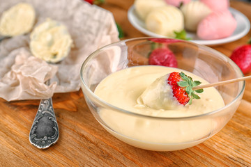 Fresh strawberry dipped in white chocolate fondue