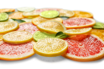 Fresh slices of citrus fruits on white background