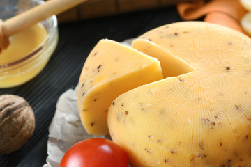 Tasty cheese on wooden table, closeup