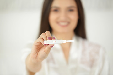 Pregnancy test in hand of young woman
