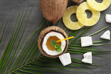 Cocktail in coconut and pineapple on gray background