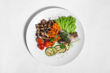 set with zucchini, mushrooms, fish, carrot and tomatoes;