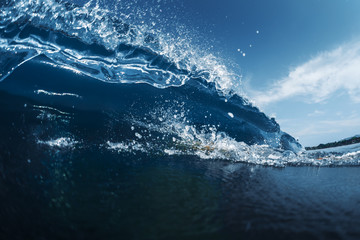 Blue ocean wave breaking on the tropical beach