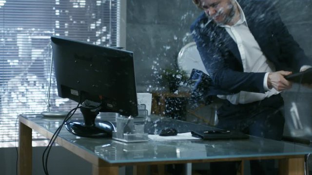  In a Private Office Businessman Loses Temper and Hits His Monitor With Keyboard, in an Act of a Rage Throws everything off the Table.  Shot on RED EPIC-W 8K Helium Cinema Camera.