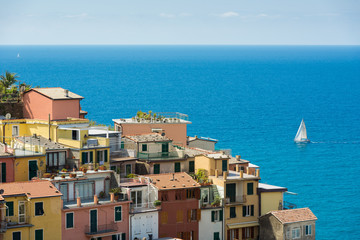 Colorfull Cinque Terre Manarola view with sailboats in sunny summer day in Italy