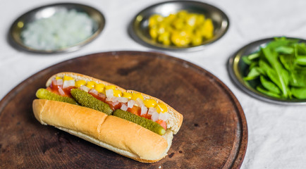 Traditional chicago style hot dog against white background
