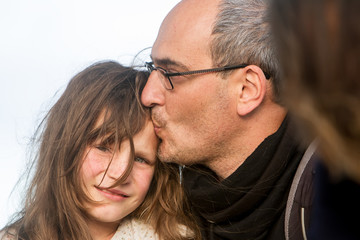 outdoor portrait of young child girl with her dad on natural background