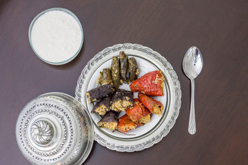Stuffed bell peppers, eggplant, and grape leaves with yoghurt top view