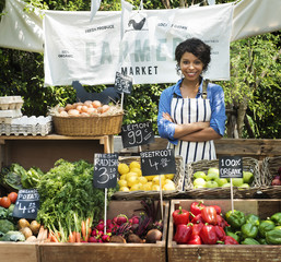 Greengrocer selling organic fresh agricultural product at farmer market