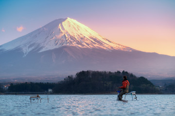 Fisherman in Kawaguchiko lake with Fuji mountain