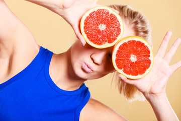 Woman holding grapefruit citrus fruit in hands