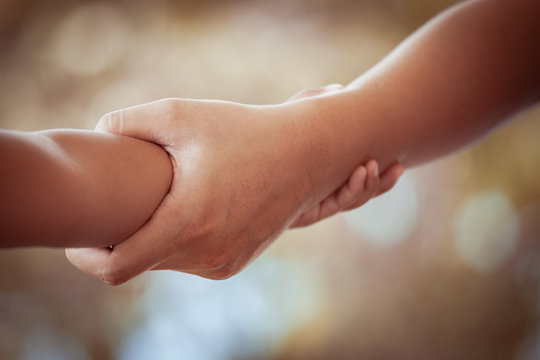 Mother and child daughter holding hand together with love in vintage color tone