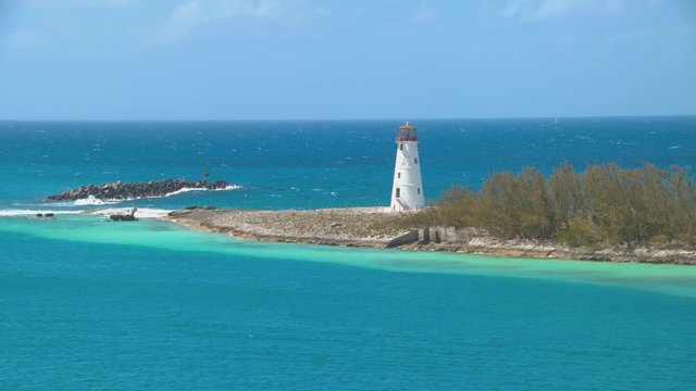 Nassau Bahamas landmark Lighthouse at Port Entrance in a Tropical Turquoise Exotic Blue Water Island Setting on a Sunny Day