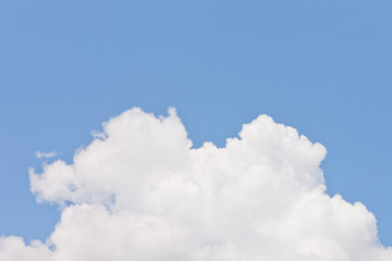 Naklejka na ściany i meble Lump of white fluffy cloud on blue sky background