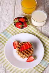 Waffels with strawberry on a white plate