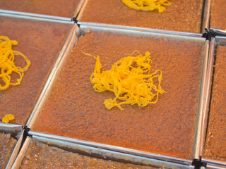 Closeup of Khanom Mor Kaeng with sweet frizzy egg topping