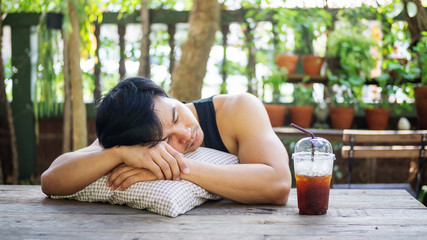 Obraz na płótnie Canvas Young Asian man sleeping in a garden.