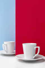 Close-up of two porcelain cups for coffee and saucers.