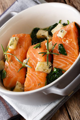 Salmon baked with spinach and roquefort cheese close-up. vertical