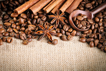 Coffee beans, ground coffee and cinnamon on burlap.