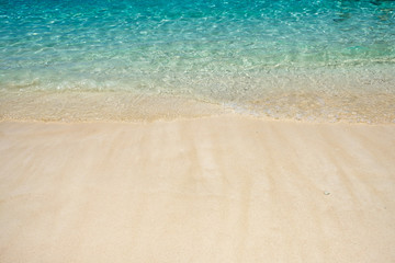 Wave of aqua sea on white sand