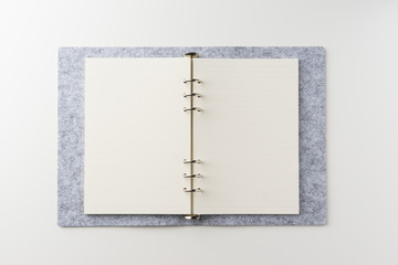 Business concept - Top view of spiral blank notebook on white background desk for mockup