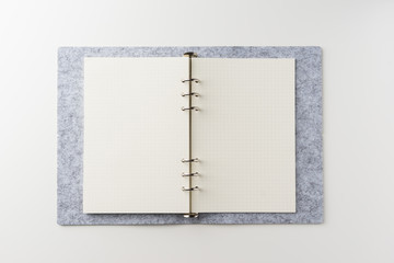 Business concept - Top view of spiral blank notebook on white background desk for mockup
