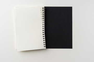 Business concept - Top view of spiral blank notebook on white background desk for mockup