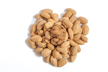 Almonds heart on isolated on white background, almonds in shells in the shape of a heart with some purified nuts on the top, happy valentines day, simplicity