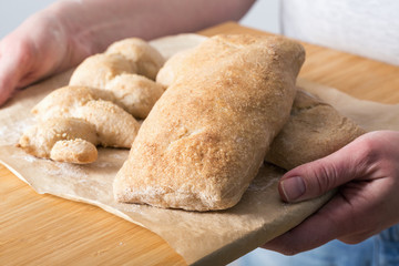 Female hands holding homemade ciabatta bread