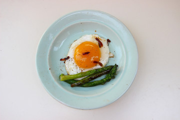 Fried eggs with bacon and asparagus. Rustic breakfast