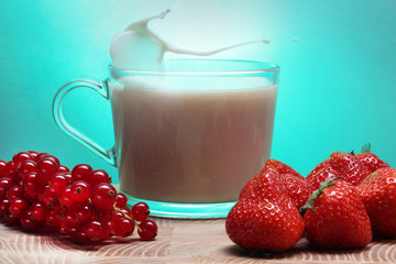 Milkshake in a Cup on a green background with berries