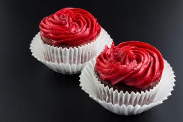 Red velvet cup cakes on black background