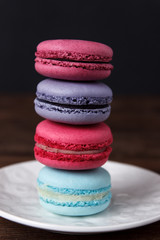 Colorful macaroons on dark wooden background. Macaroons close up 