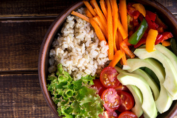 Vegan buddha bowl on wooden background. Top view. Vegetarian, healthy, detox food concept.
