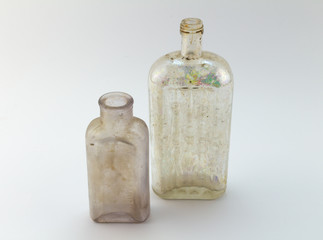 Old medicine bottles on white background