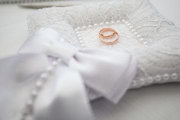 Wedding gold rings on the pillow