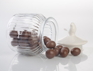 jar or glass jar with chocolate ball on the background.