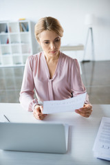 serious businesswoman working with documents