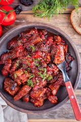 Meat with tomatoes and prunes, top view, selective focus