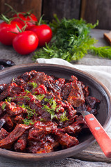 Stewed beef in tomato sauce with prunes, selective focus