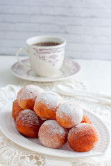 Freshly baked cheese donuts with powdered sugar, selective focus
