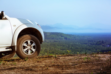 Fototapeta na wymiar 4x4 car on mountains valley backdrop