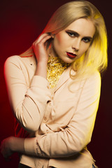 Elegant woman with bright makeup and gold foil on her neck