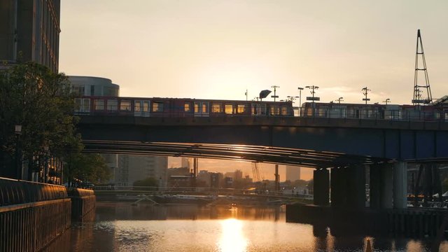Passenger trains crossing on the platform at sunset