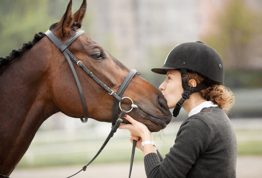 Attractive Young Woman Kissing her Horse