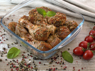 Chicken legs in marinade on a kitchen table. 