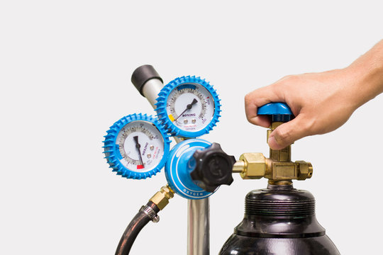 Pressure Tank and Regulator Gauges with Hand  isolated on white background